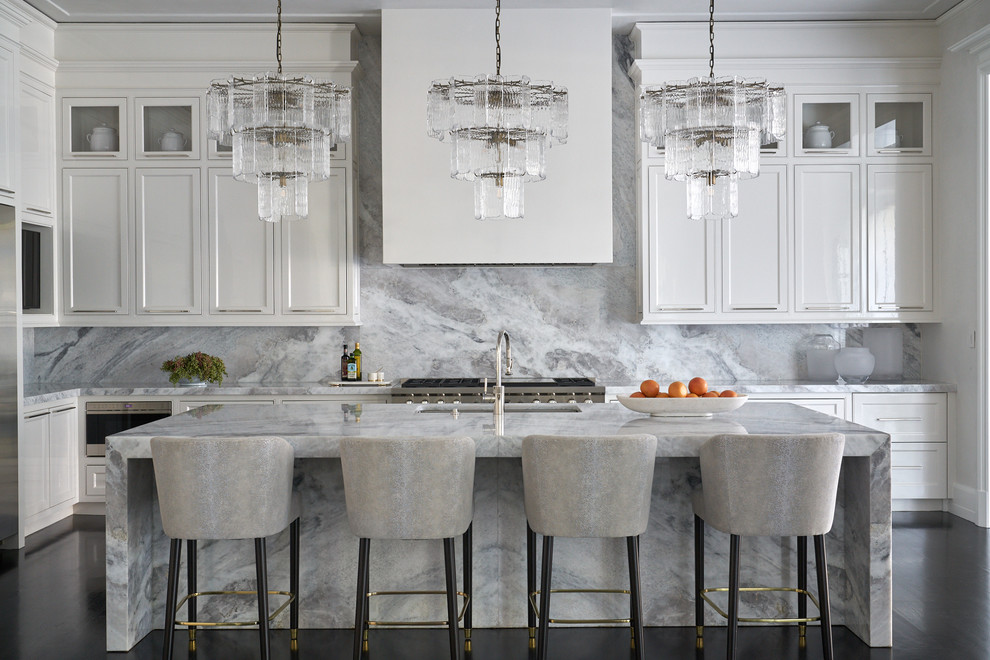 Inspiration for a kitchen in Houston with marble benchtops and with island.