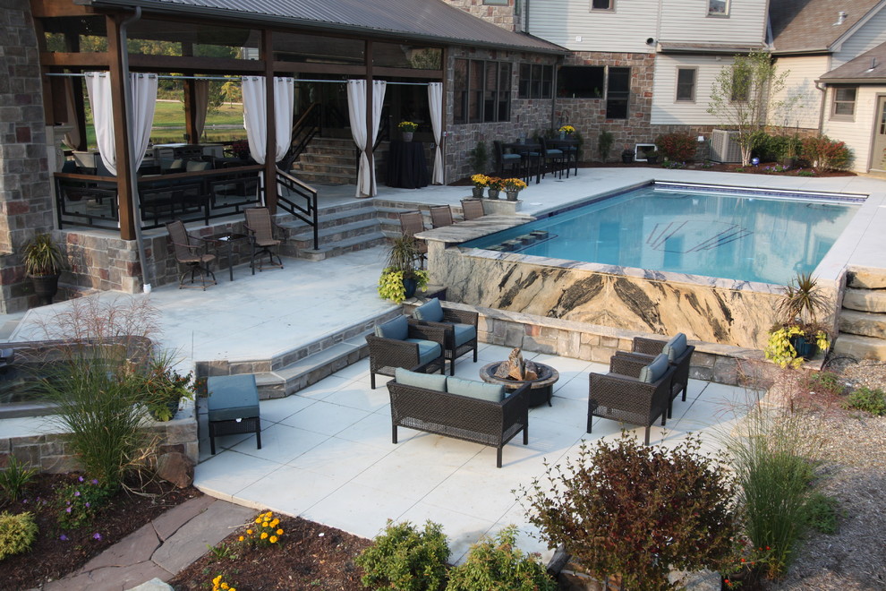 This is an example of a traditional patio in Cleveland with a fire feature.