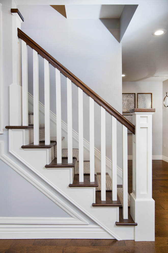 Inspiration for a transitional wood straight staircase in Detroit with wood railing and wood risers.