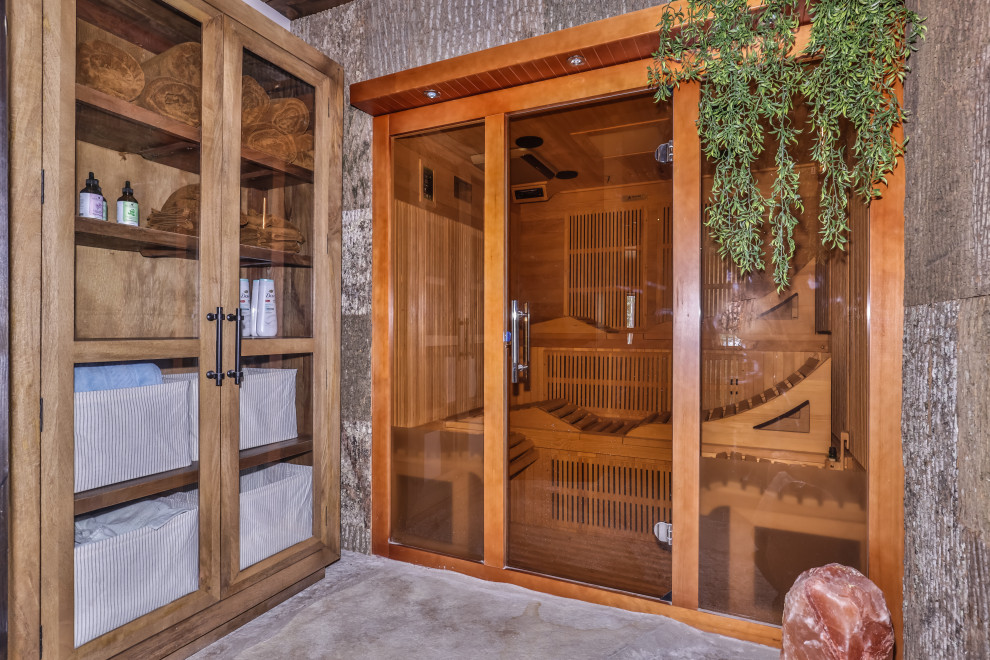 Example of a mid-sized mountain style walk-out gray floor and wood ceiling basement design with gray walls