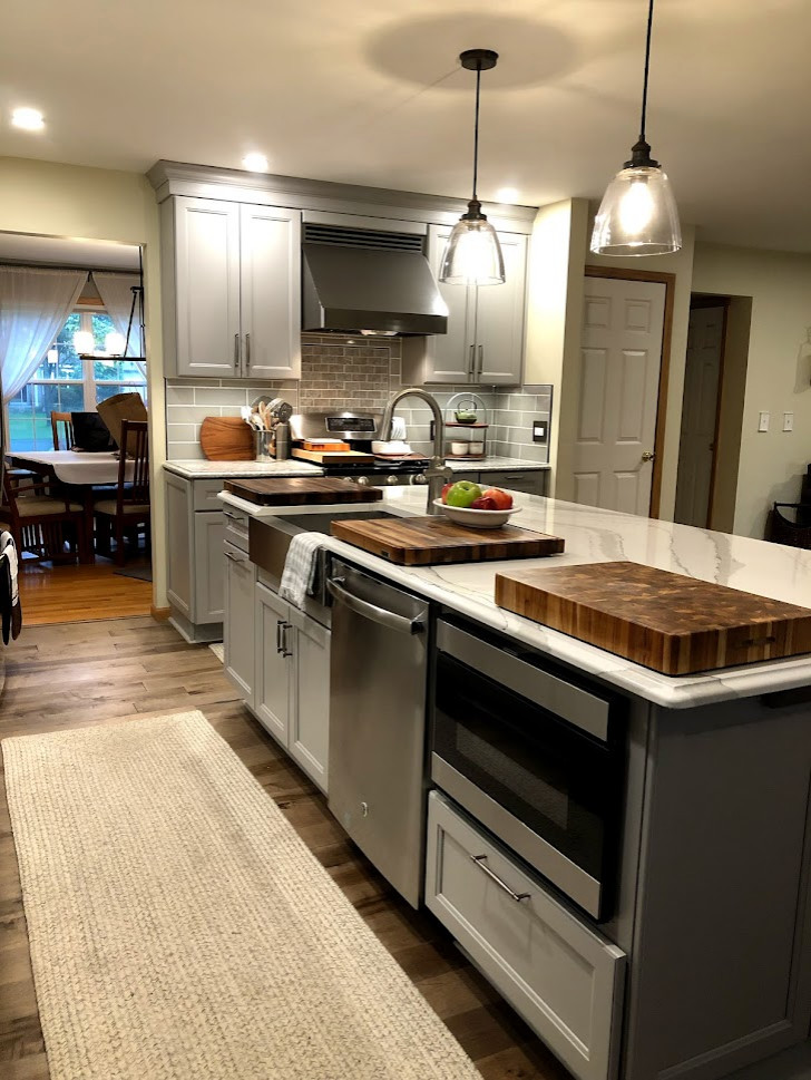 Inspiration for a mid-sized cottage l-shaped open concept kitchen remodel in New York with recessed-panel cabinets, gray cabinets, quartz countertops, an island and white countertops