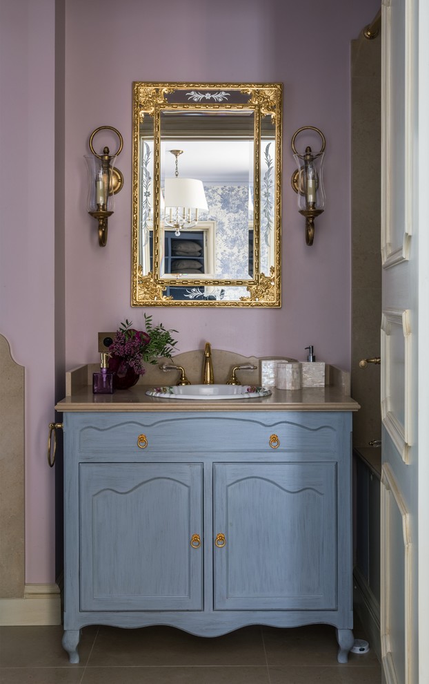 Design ideas for a transitional bathroom in Moscow with recessed-panel cabinets, blue cabinets, purple walls, a drop-in sink, beige floor and beige benchtops.