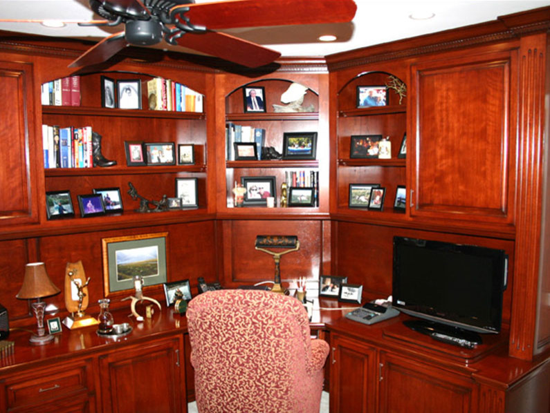 This is an example of a contemporary study room in Orange County with carpet and a built-in desk.