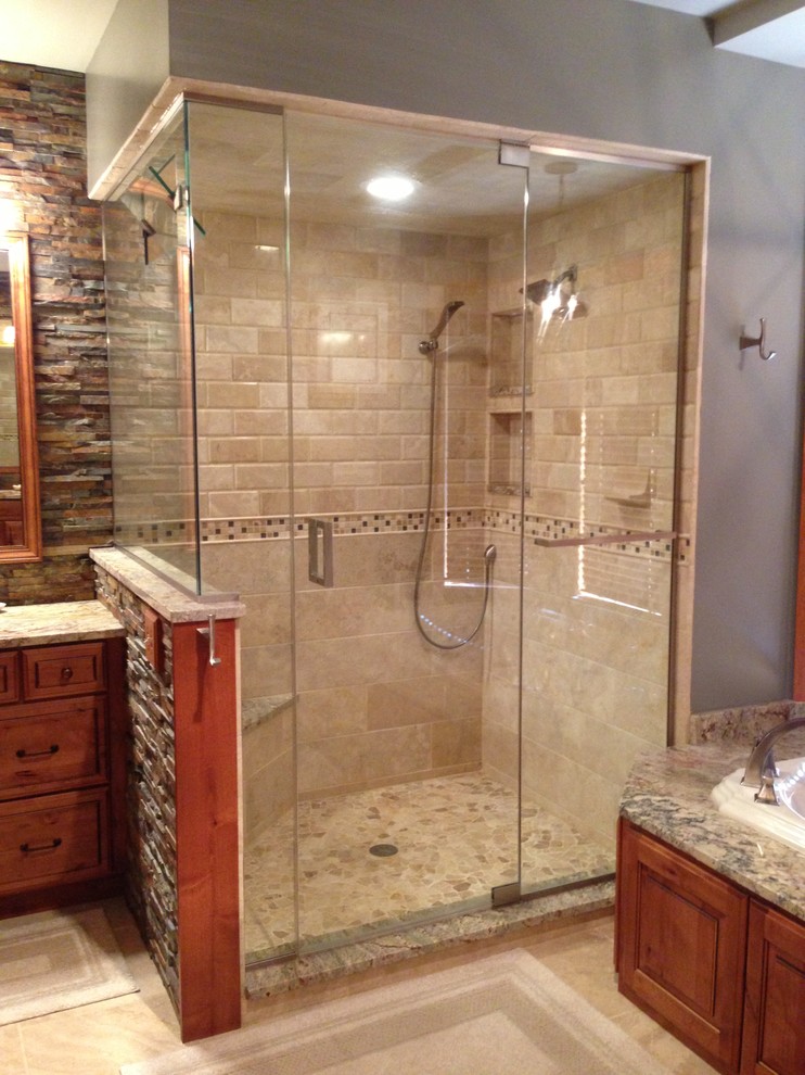 Drop-in bathtub - rustic drop-in bathtub idea in St Louis with raised-panel cabinets, granite countertops and medium tone wood cabinets