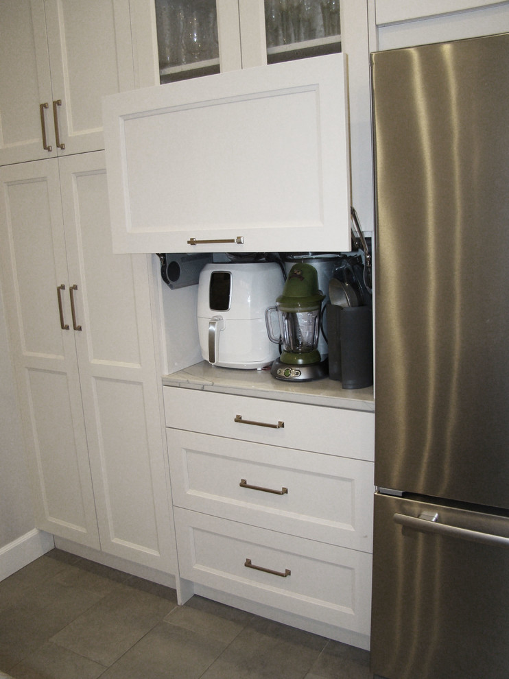 Large transitional u-shaped ceramic tile and gray floor eat-in kitchen photo in Denver with a double-bowl sink, recessed-panel cabinets, white cabinets, granite countertops, white backsplash, marble backsplash, stainless steel appliances, an island and multicolored countertops