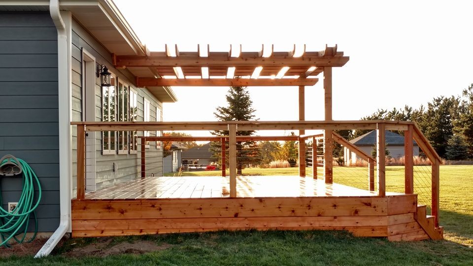Inspiration for a large rustic deck remodel with a pergola