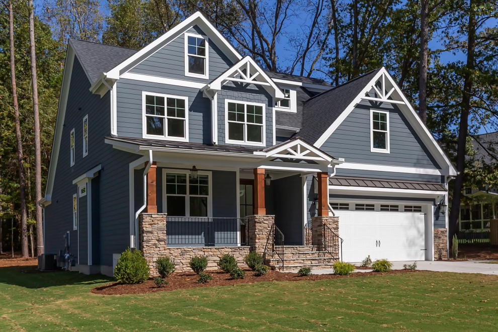 Inspiration for a large traditional two-storey grey house exterior in Raleigh with concrete fiberboard siding, a gable roof and a shingle roof.