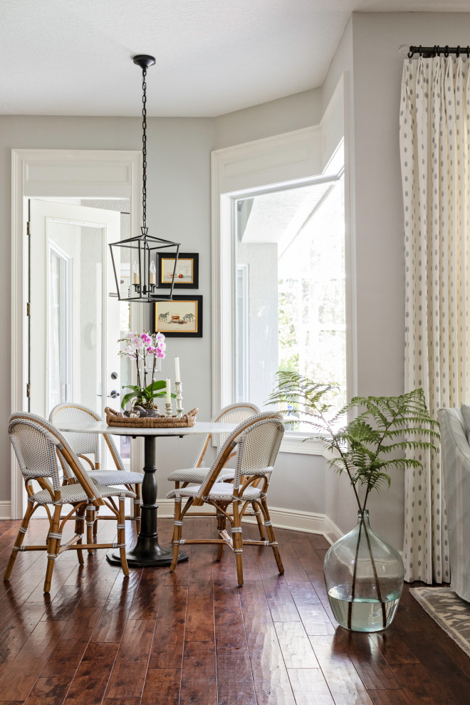 Inspiration for a small country dining room in Orlando with grey walls, medium hardwood floors and brown floor.