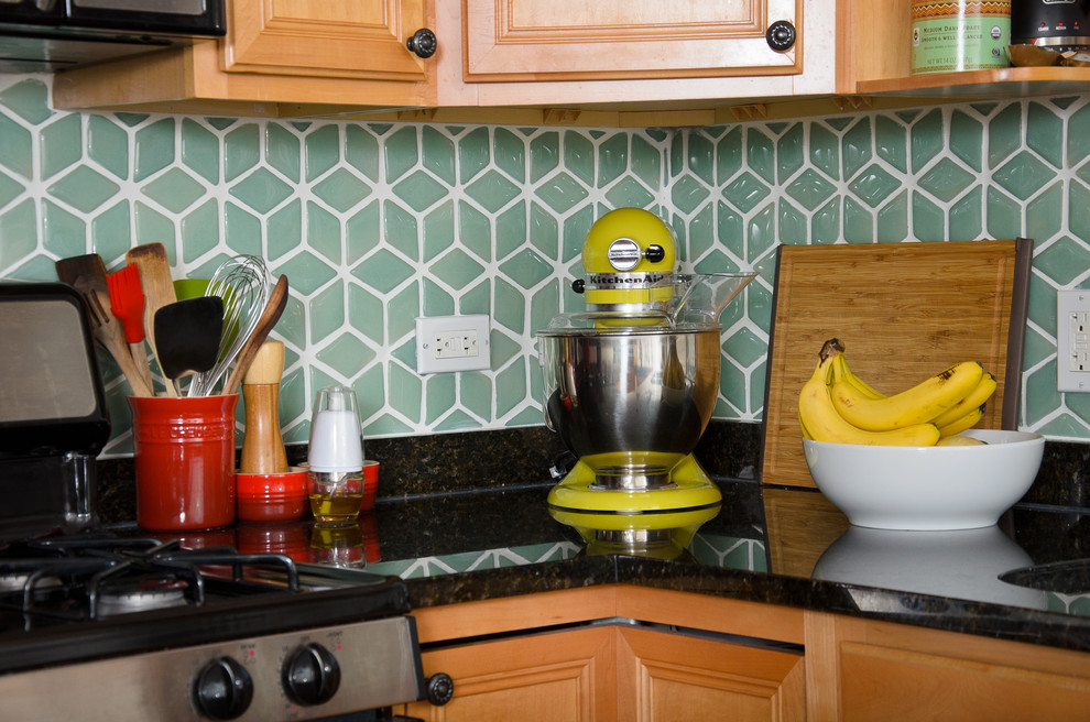 Mid-sized transitional u-shaped medium tone wood floor eat-in kitchen photo in Chicago with an undermount sink, raised-panel cabinets, medium tone wood cabinets, granite countertops, green backsplash, porcelain backsplash, stainless steel appliances and a peninsula