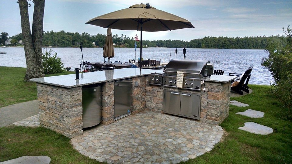 Design ideas for a small beach style backyard patio in Manchester with an outdoor kitchen, concrete pavers and no cover.