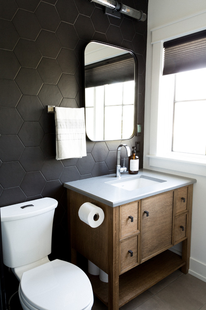 Mid-sized transitional 3/4 bathroom in Toronto with recessed-panel cabinets, light wood cabinets, an open shower, a one-piece toilet, black tile, stone tile, white walls, porcelain floors, an undermount sink, engineered quartz benchtops, white floor, a hinged shower door and white benchtops.