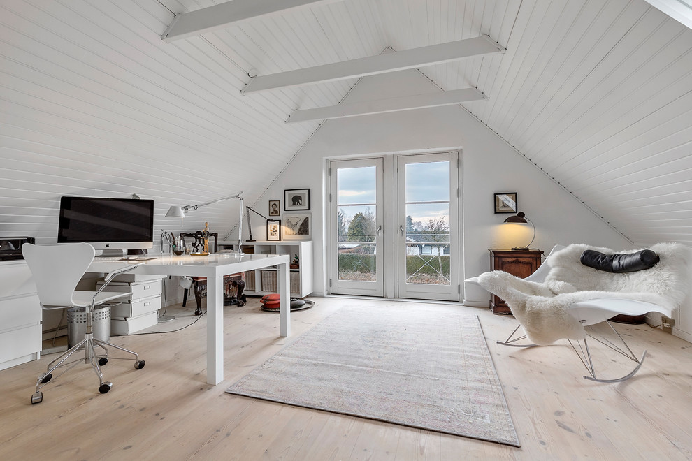 Photo of a mid-sized scandinavian study room in Copenhagen with white walls, light hardwood floors, beige floor and a freestanding desk.