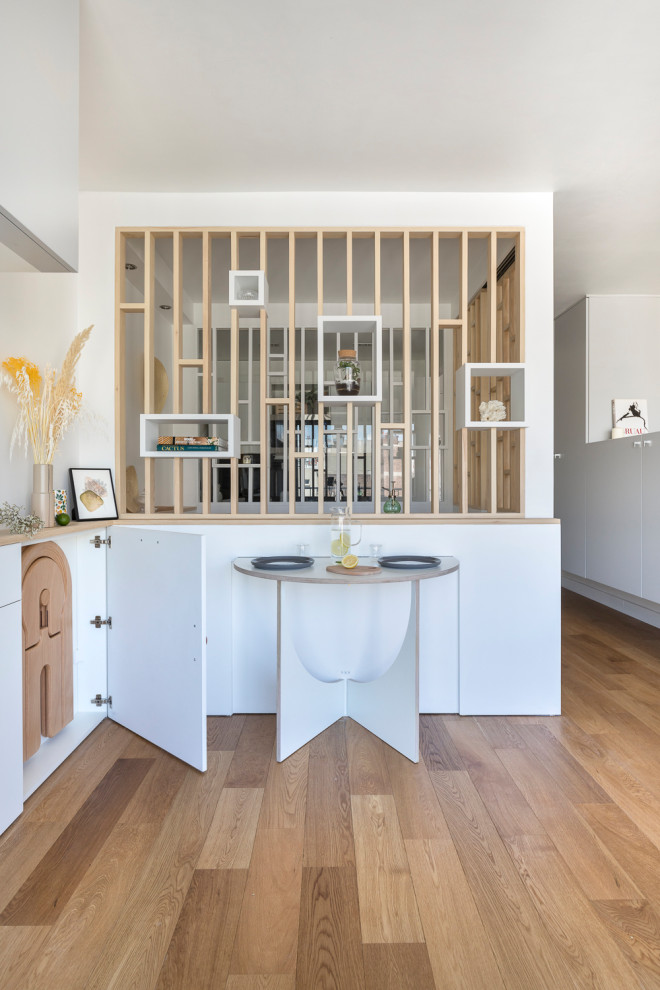 Photo of a contemporary open plan dining in Paris with plywood floors.