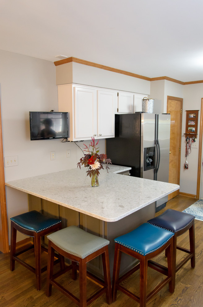 Kitchen - transitional medium tone wood floor kitchen idea in Cincinnati with gray cabinets, quartz countertops, white backsplash, subway tile backsplash and white countertops