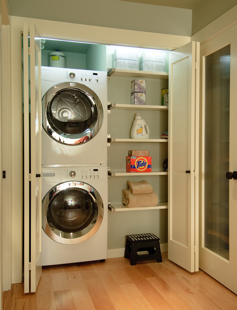 Design ideas for a transitional laundry room in Seattle with a stacked washer and dryer.
