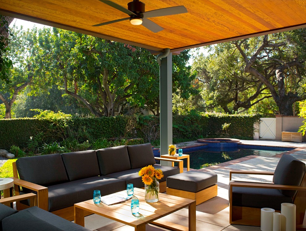 Photo of a large transitional backyard patio in Los Angeles with a roof extension and concrete slab.