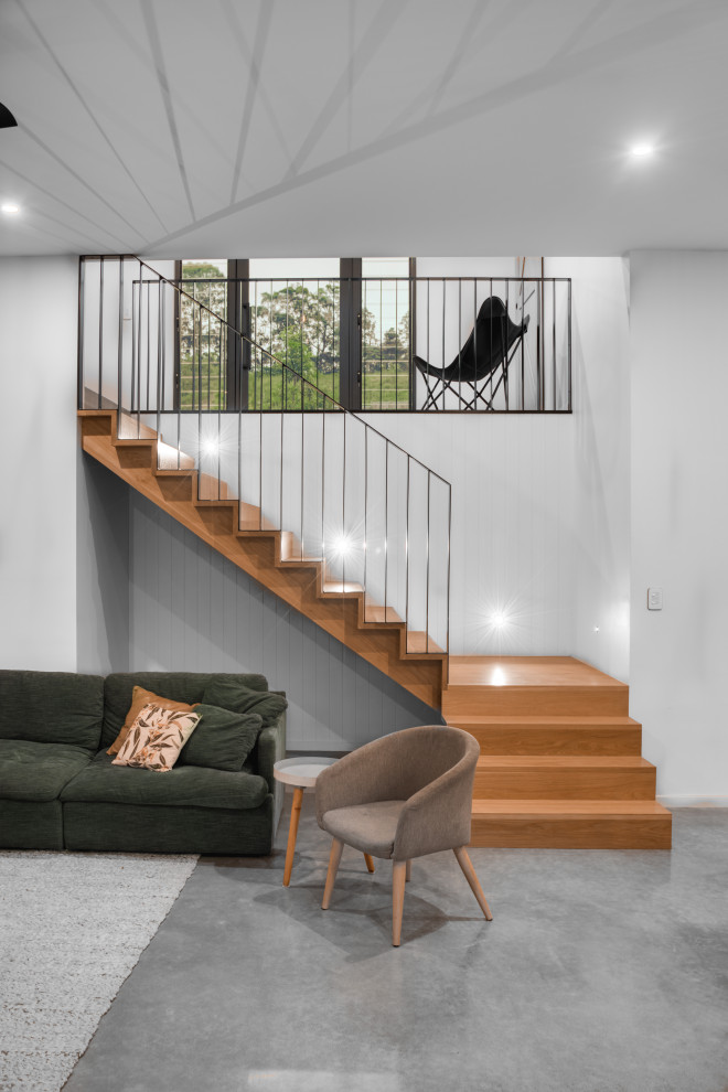 This is an example of a modern wood l-shaped staircase in Sunshine Coast with wood risers and metal railing.