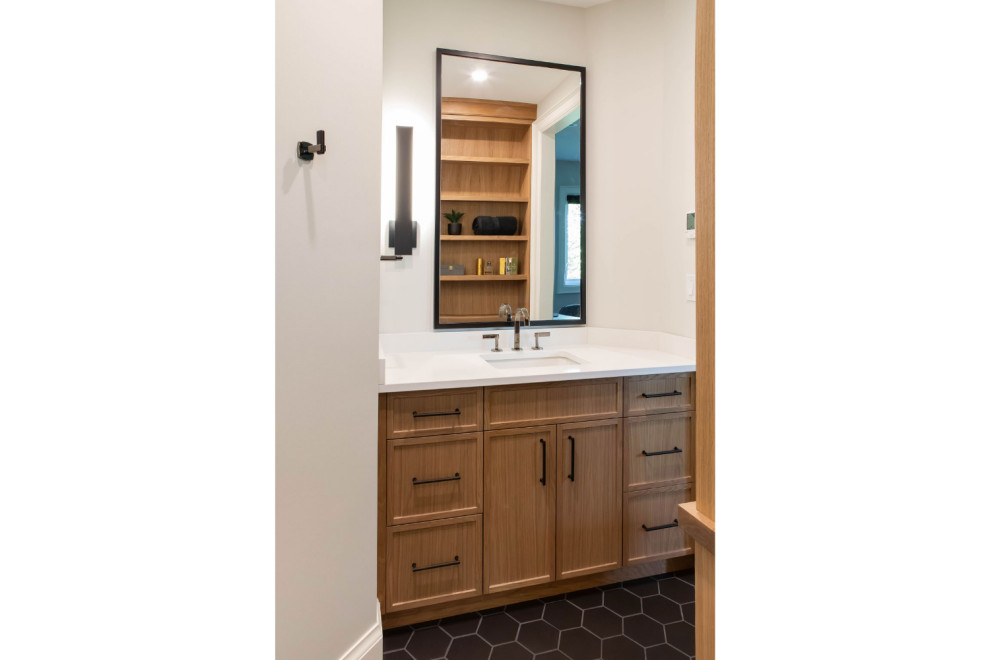 Bathroom - mid-sized transitional ceramic tile, black floor and single-sink bathroom idea in Toronto with flat-panel cabinets, medium tone wood cabinets, a one-piece toilet, an integrated sink, quartz countertops, white countertops and a built-in vanity