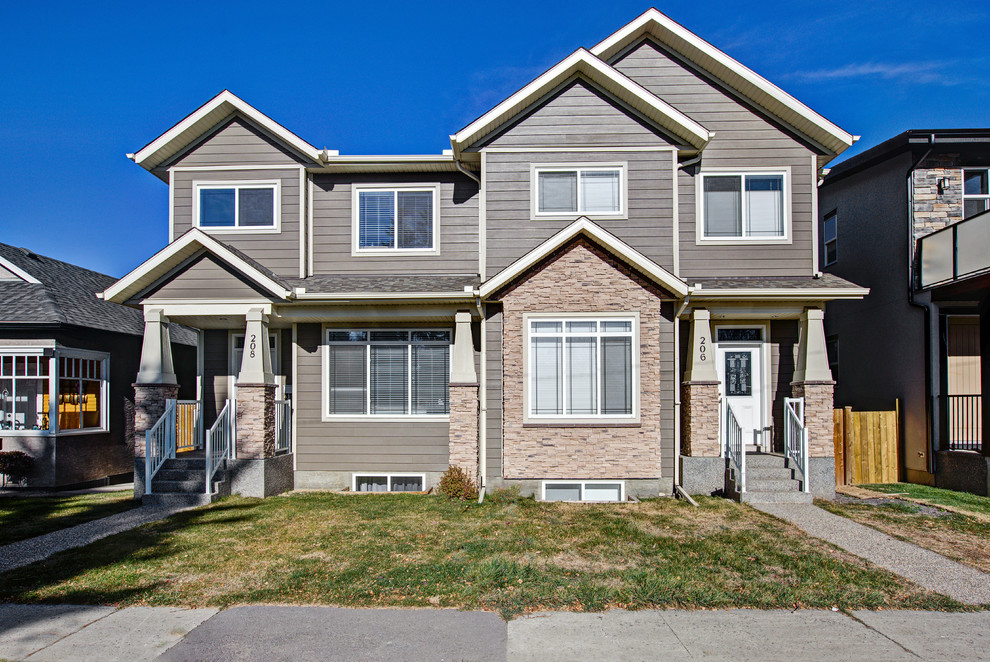 Mid-sized transitional beige two-story wood gable roof photo in Calgary