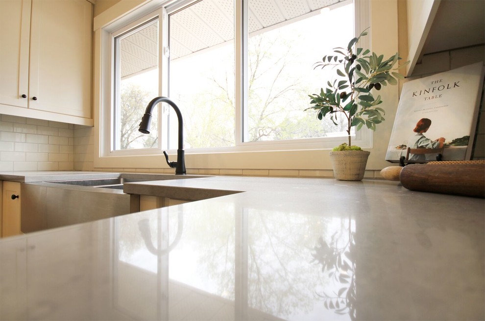 Example of a porcelain tile kitchen design with quartz countertops, ceramic backsplash and gray countertops
