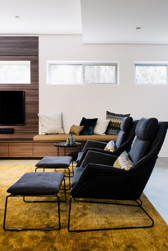 This is an example of a contemporary open concept living room in Sydney with white walls, concrete floors, no fireplace and a built-in media wall.