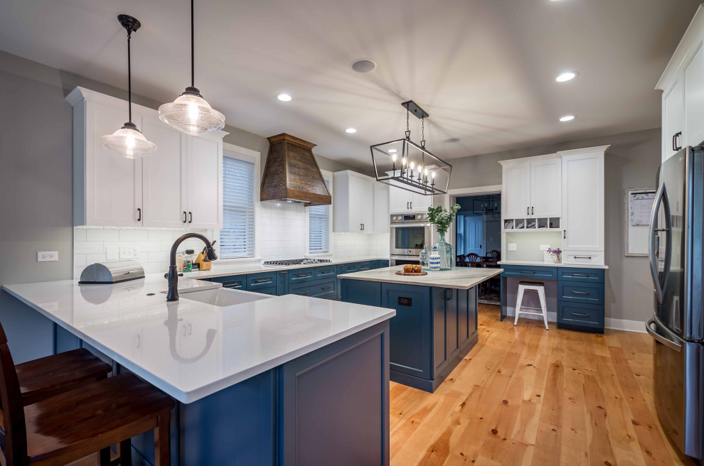 Large farmhouse l-shaped light wood floor, brown floor and wallpaper ceiling eat-in kitchen photo in Chicago with a farmhouse sink, shaker cabinets, turquoise cabinets, marble countertops, white backsplash, porcelain backsplash, stainless steel appliances, an island and multicolored countertops