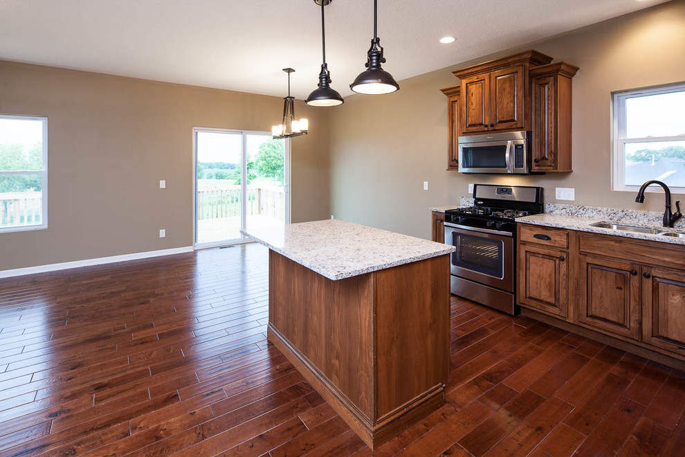 Example of a mountain style dark wood floor eat-in kitchen design in Chicago with a double-bowl sink, dark wood cabinets, granite countertops, stainless steel appliances and an island