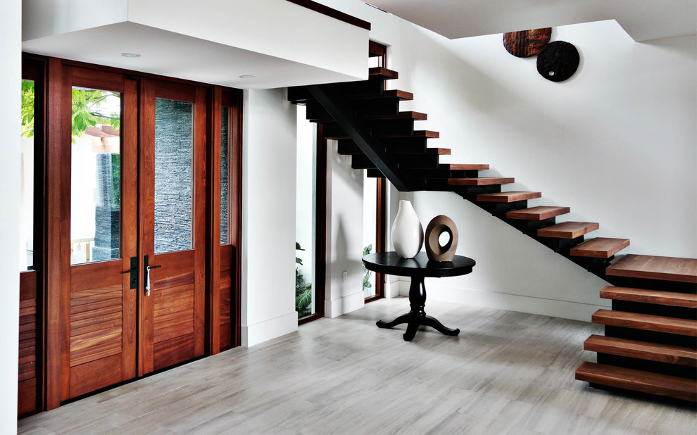 Design ideas for a contemporary foyer in Miami with a double front door and a dark wood front door.