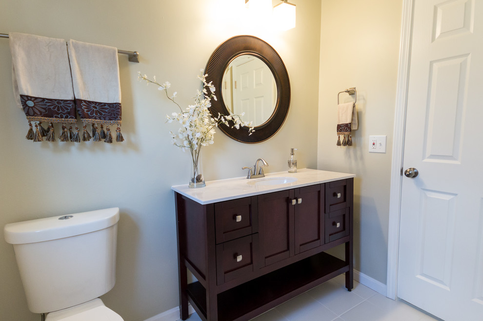 Design ideas for a transitional master bathroom in Cincinnati with an undermount sink, shaker cabinets, dark wood cabinets, marble benchtops, gray tile, ceramic tile, grey walls and ceramic floors.