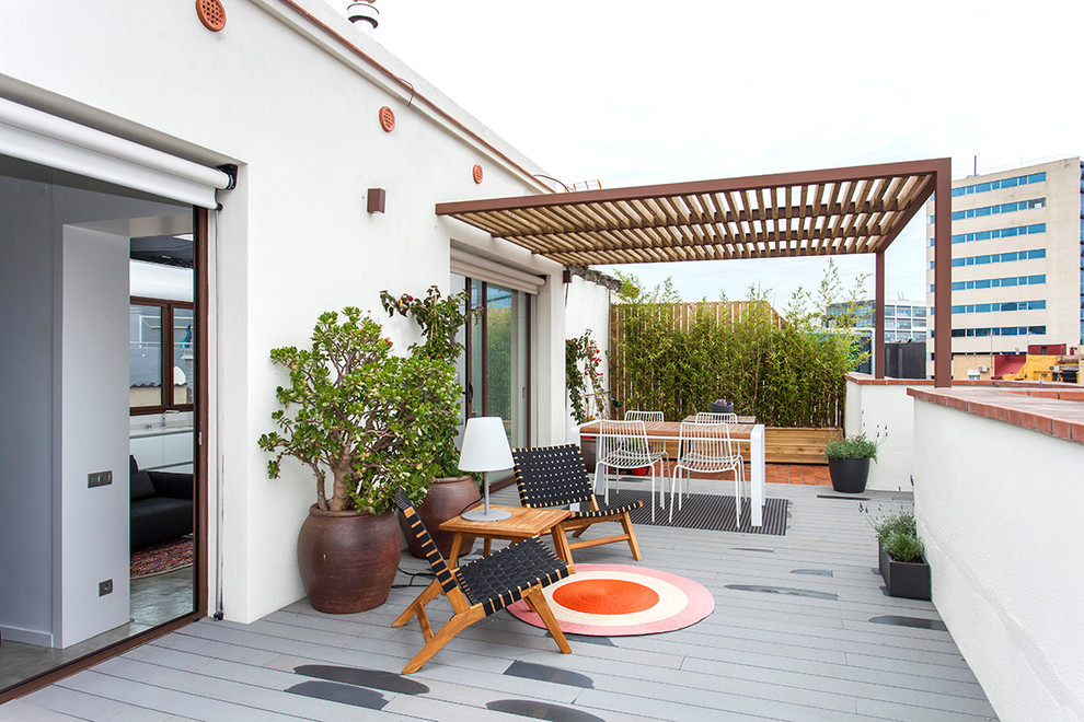 Photo of a contemporary rooftop and rooftop deck in Barcelona with a container garden and a pergola.