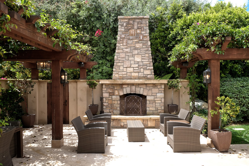 Inspiration for a mid-sized mediterranean courtyard patio in San Diego with a fire feature, a pergola and concrete slab.