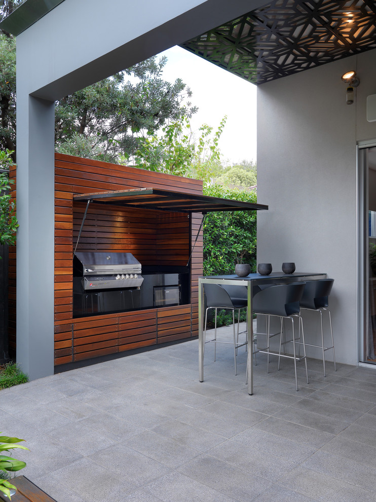Large contemporary backyard patio in Melbourne with tile and a roof extension.