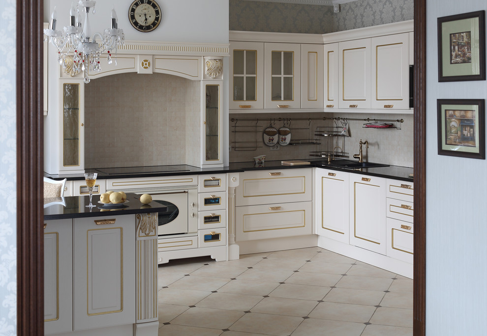 Photo of a mid-sized traditional l-shaped eat-in kitchen in Other with a drop-in sink, raised-panel cabinets, white cabinets, marble benchtops, beige splashback, mosaic tile splashback, white appliances, porcelain floors and with island.