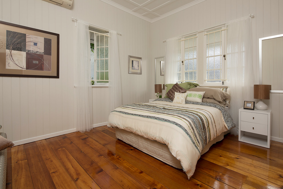 This is an example of a small transitional master bedroom in Gold Coast - Tweed with beige walls and medium hardwood floors.