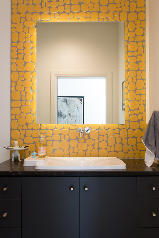 Photo of an expansive modern 3/4 bathroom in San Diego with black cabinets, yellow tile, a drop-in sink, flat-panel cabinets, a drop-in tub, a shower/bathtub combo, a one-piece toilet, ceramic tile, white walls and granite benchtops.