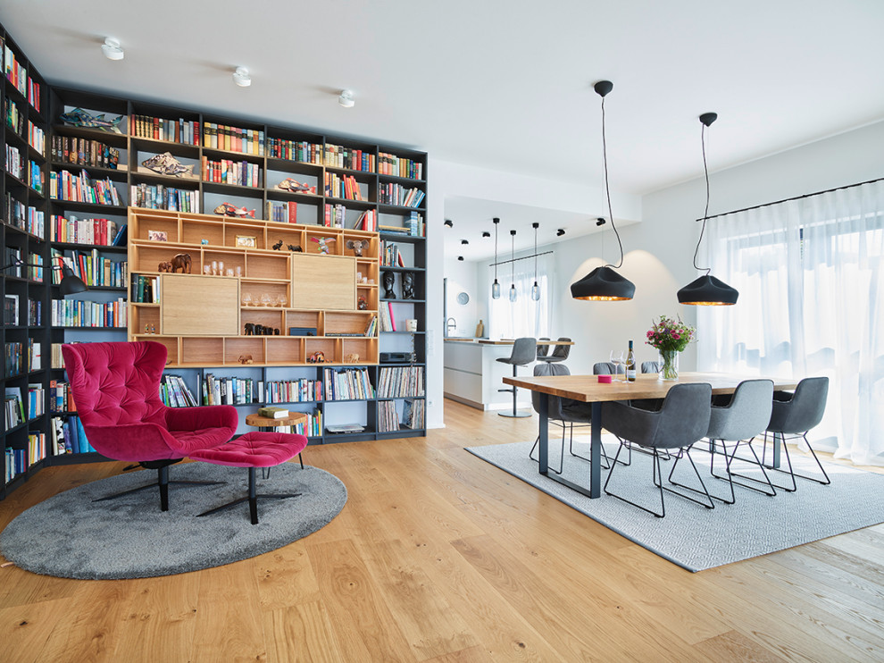 This is an example of an expansive contemporary open plan dining in Frankfurt with white walls, medium hardwood floors, a corner fireplace and beige floor.