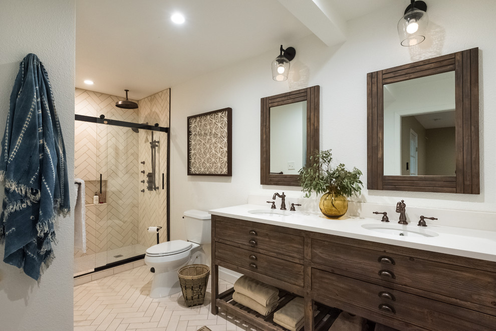 Inspiration for a mid-sized transitional master bathroom in Other with white tile, limestone floors, quartzite benchtops, white benchtops, dark wood cabinets, an alcove shower, a two-piece toilet, white walls, beige floor, a sliding shower screen and flat-panel cabinets.