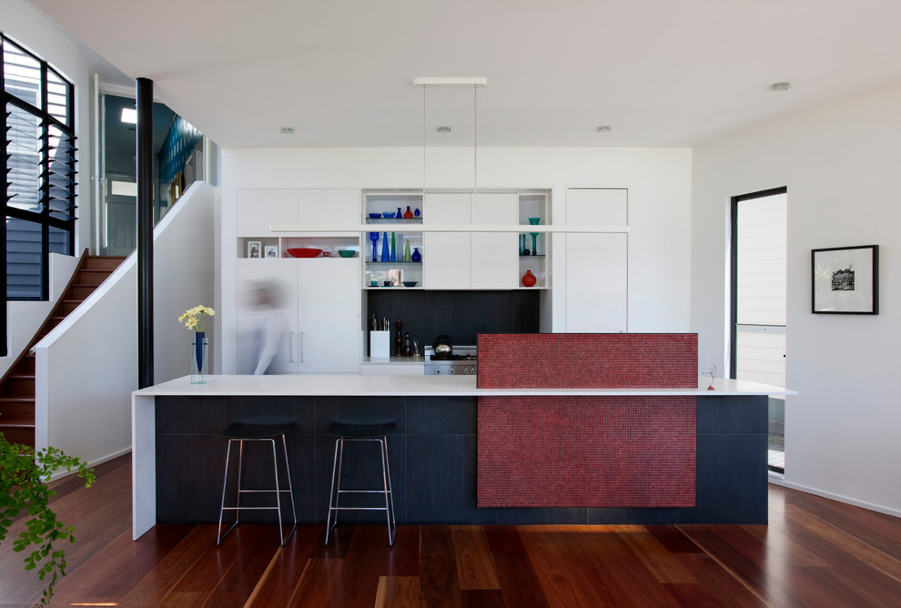 Inspiration for a contemporary galley kitchen in Melbourne with flat-panel cabinets, white cabinets and black splashback.