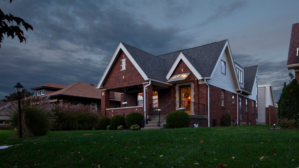 Inspiration for a mid-sized traditional two-storey brick white exterior in Indianapolis with a gable roof.
