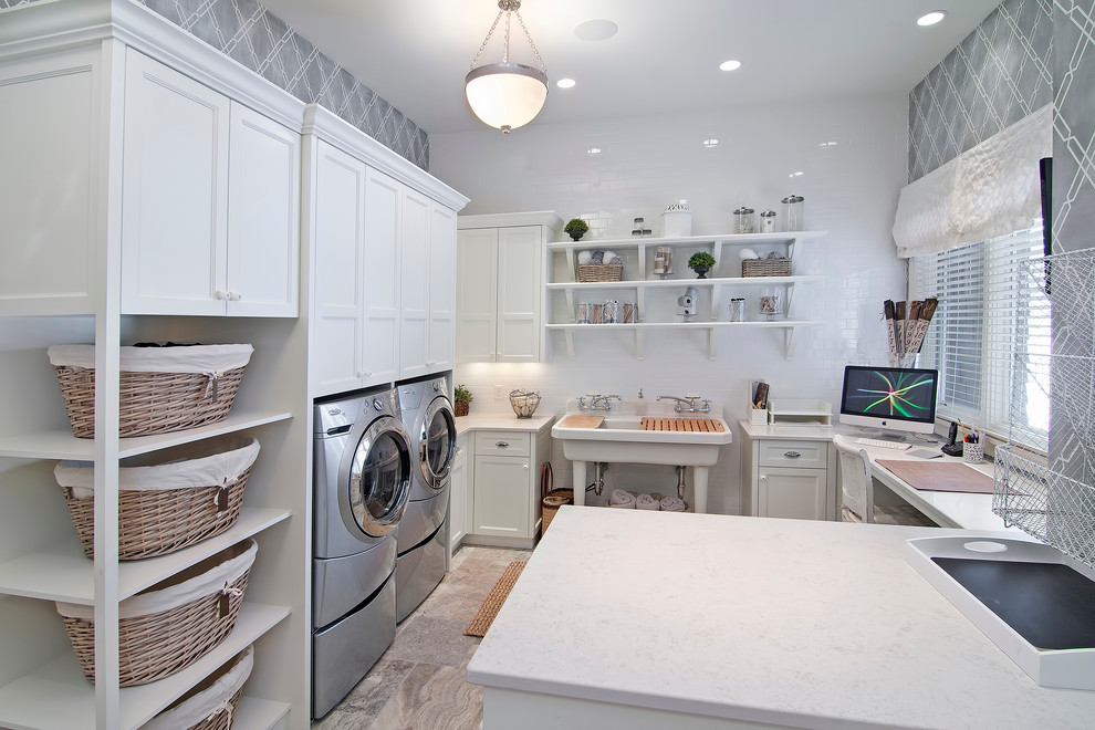 Photo of a traditional u-shaped utility room in Minneapolis with an utility sink, recessed-panel cabinets, white cabinets, grey walls and a side-by-side washer and dryer.
