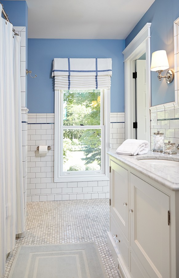 Photo of a country 3/4 bathroom in Grand Rapids with grey cabinets, a drop-in tub, a shower/bathtub combo, white tile, subway tile, blue walls, an undermount sink, marble benchtops, grey floor, a shower curtain, grey benchtops, a single vanity, a built-in vanity and shaker cabinets.
