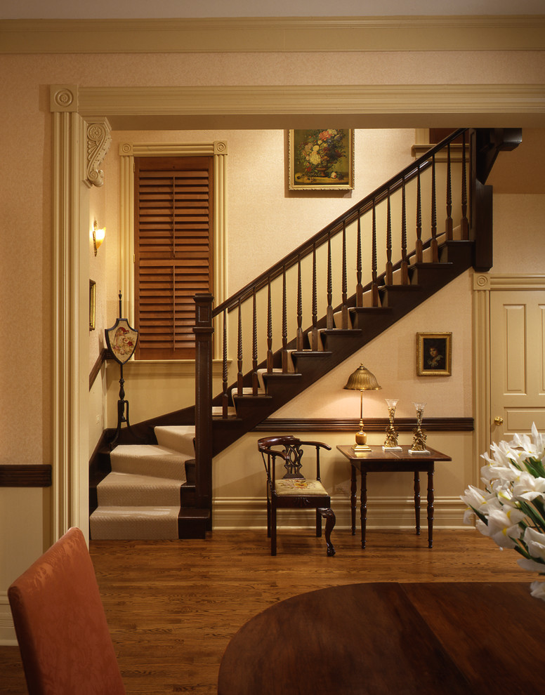 This is an example of a large traditional hallway in Chicago with beige walls and medium hardwood floors.