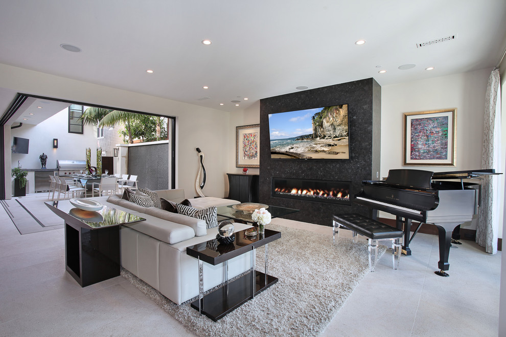 Photo of a contemporary open concept living room in Phoenix with a music area, white walls, a ribbon fireplace, a wall-mounted tv, concrete floors, a stone fireplace surround and grey floor.