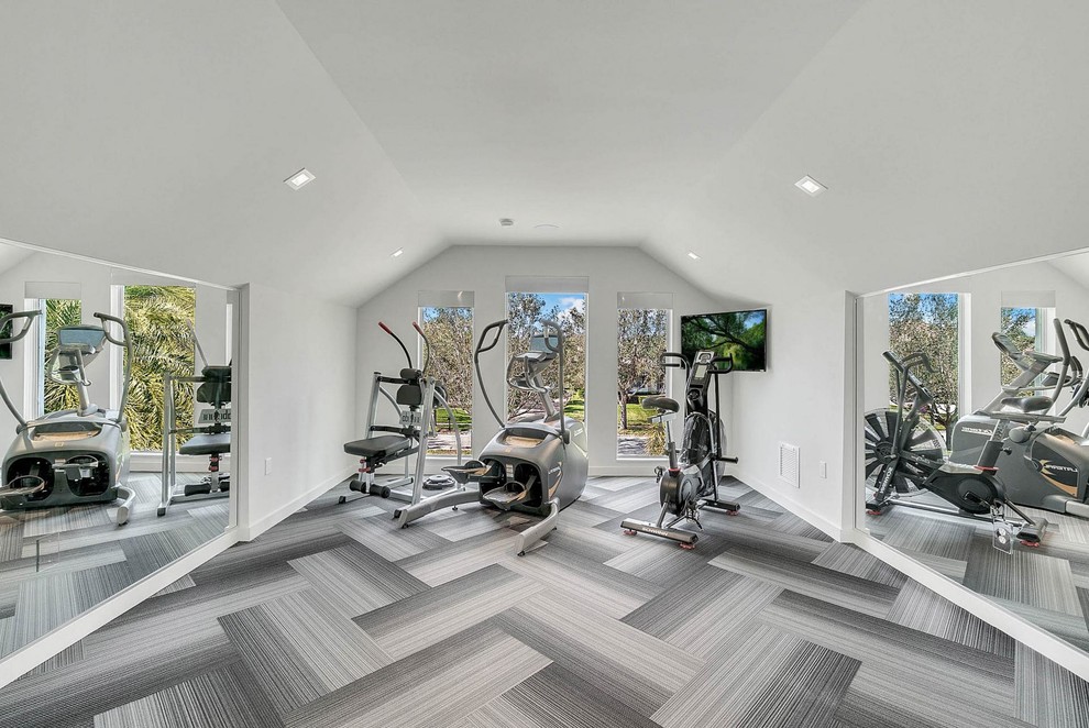 This is an example of a mid-sized contemporary multipurpose gym in Orlando with grey walls and grey floor.