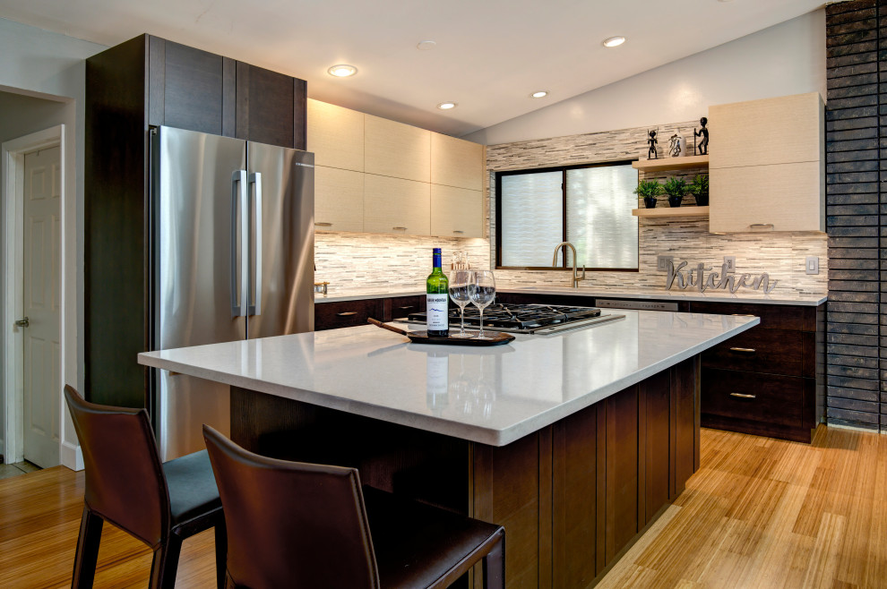 Small trendy l-shaped bamboo floor and vaulted ceiling eat-in kitchen photo in Seattle with a single-bowl sink, flat-panel cabinets, light wood cabinets, quartz countertops, gray backsplash, porcelain backsplash, stainless steel appliances, an island and white countertops