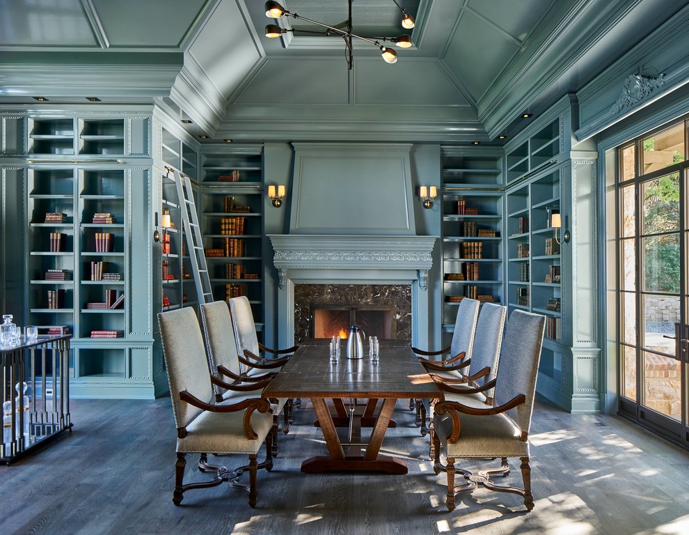 Large traditional dining room in Denver with blue walls, a standard fireplace, brown floor, dark hardwood floors and a stone fireplace surround.