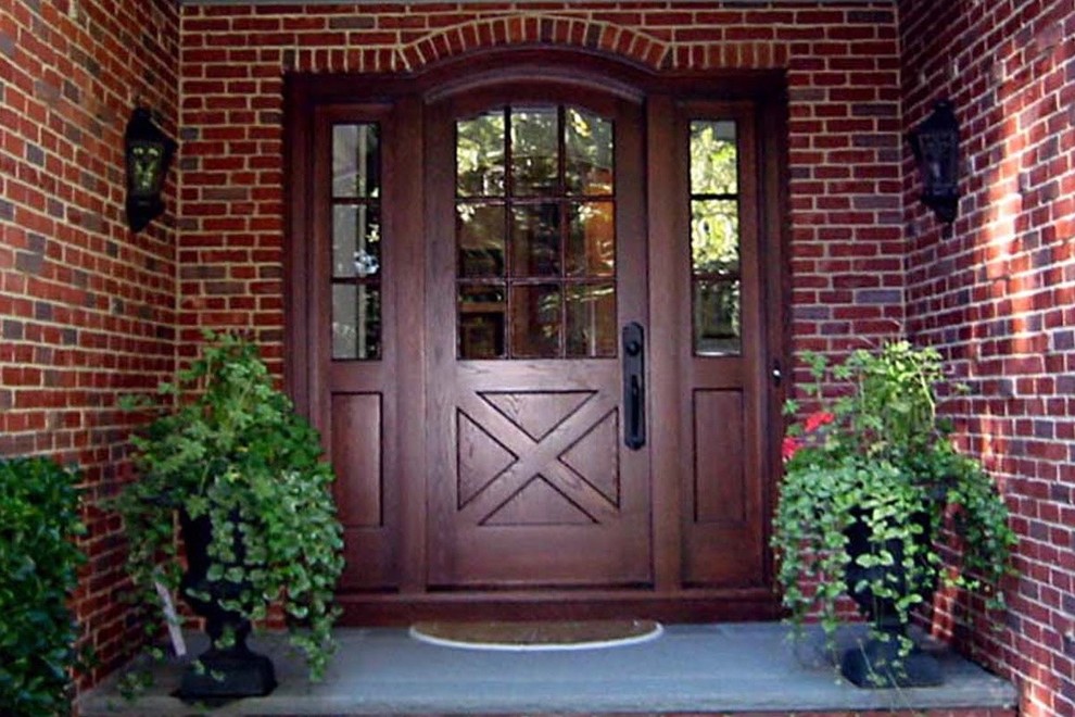 Example of a large classic blue floor entryway design in Boston with red walls and a dark wood front door