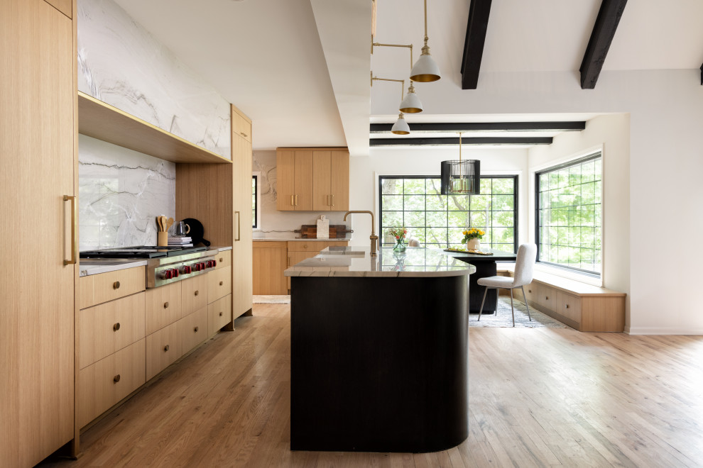 This is an example of a l-shaped open plan kitchen in Kansas City with a belfast sink, flat-panel cabinets, light wood cabinets, quartz worktops, multi-coloured splashback, stone slab splashback, stainless steel appliances, light hardwood flooring, an island, brown floors and multicoloured worktops.