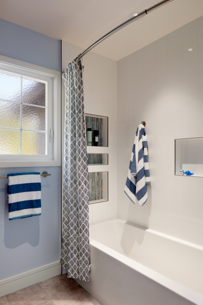 На фото: детская ванная комната среднего размера в стиле неоклассика (современная классика) с ванной в нише, синей плиткой, синими стенами и встроенной тумбой с