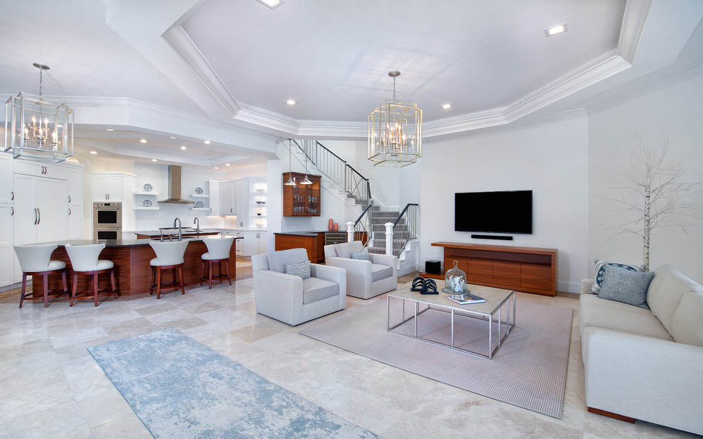 Photo of a mid-sized transitional open concept family room in Miami with a home bar, white walls, porcelain floors, no fireplace, a wall-mounted tv and beige floor.